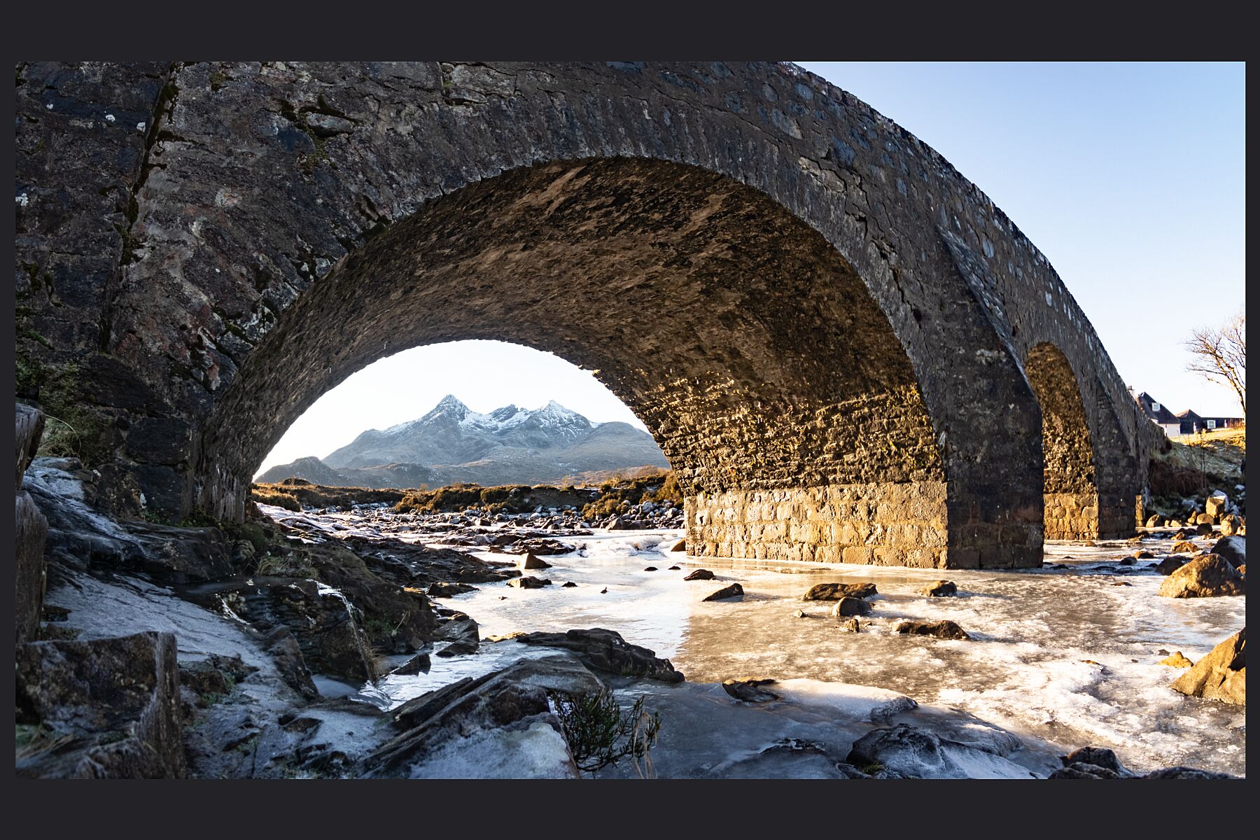 The Black Cuillin ridge framed by the old Sligachan bridge, and a frozen Sligachan river.
 
This amazing landscape is available in A3, A2 and A1 sizes, as print only, or with a choice of wooden frames in White, Black and Oak